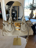 This is a Chloé Paddington handbag in cream leather with signature gold-tone hardware