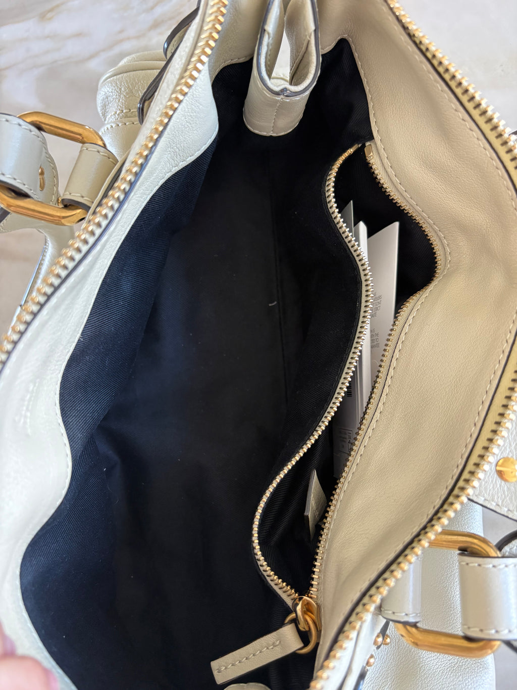 This is a Chloé Paddington handbag in cream leather with signature gold-tone hardware