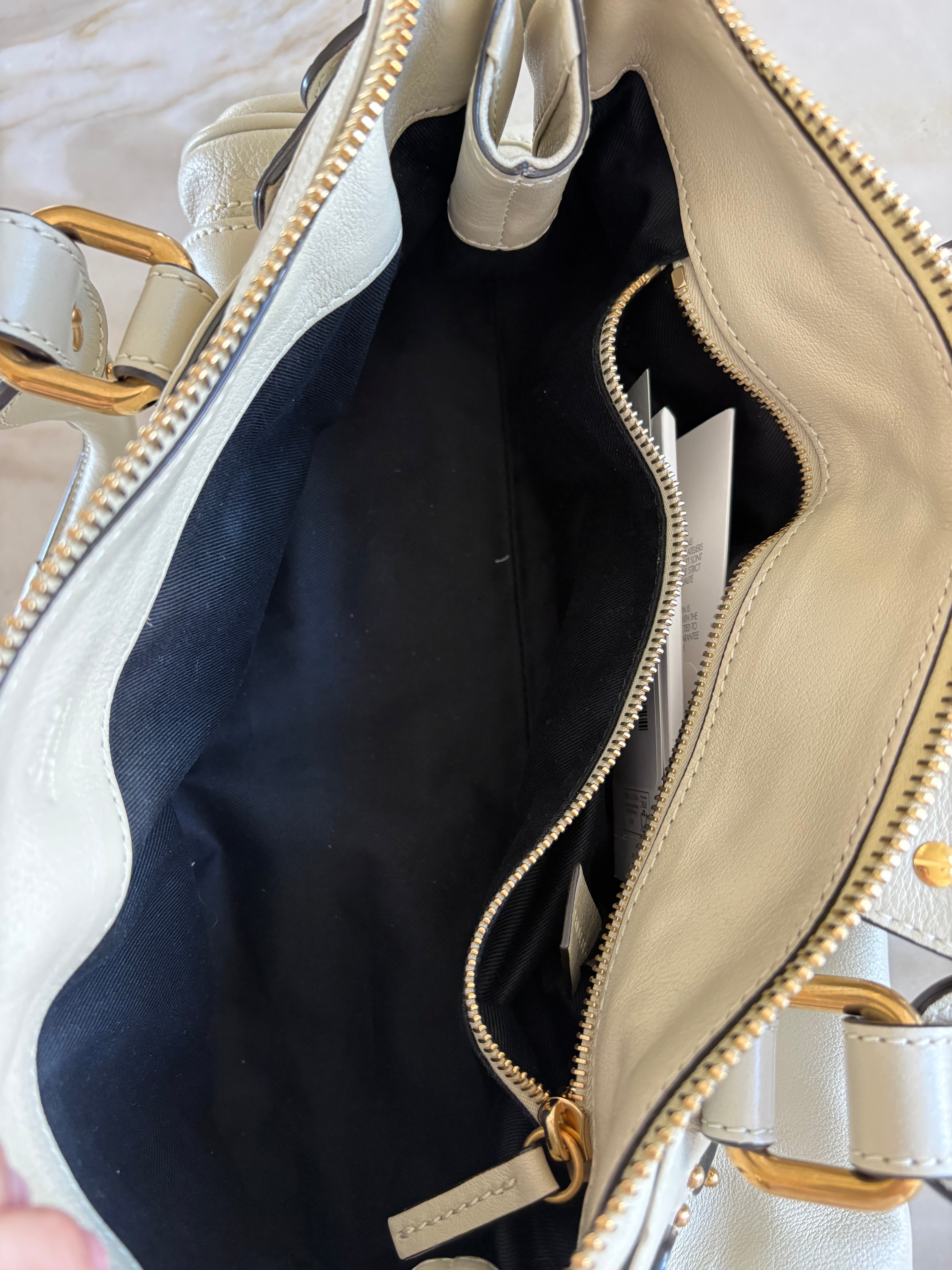 This is a Chloé Paddington handbag in cream leather with signature gold-tone hardware