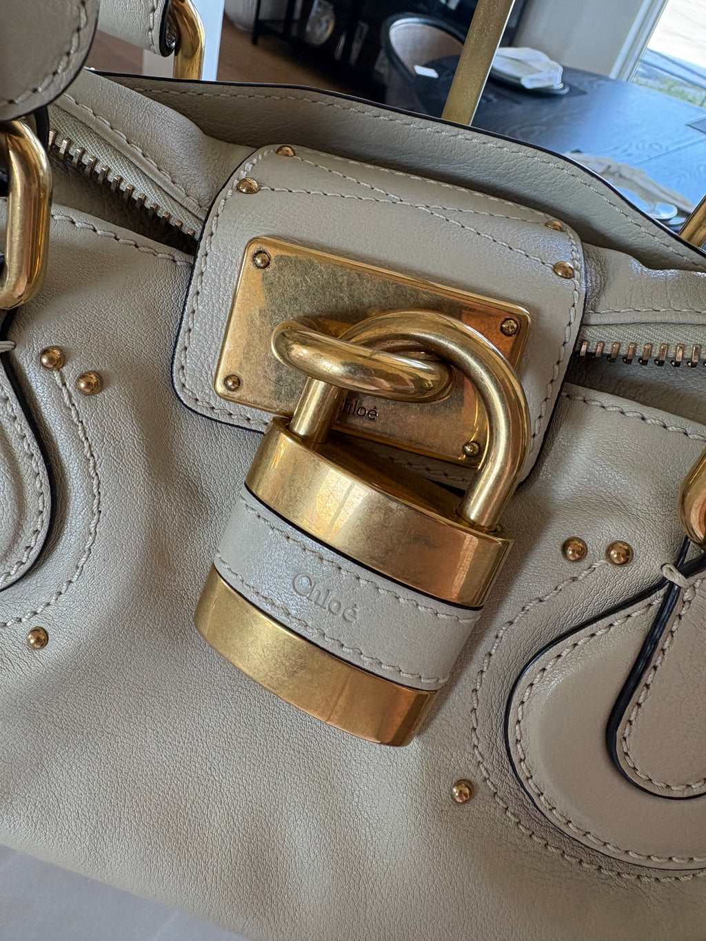 This is a Chloé Paddington handbag in cream leather with signature gold-tone hardware